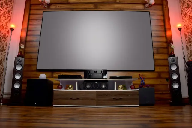 Stylish home theatre with a large screen, audio system and decor