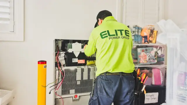 Technician installing technology equipment in a home in New South Wales